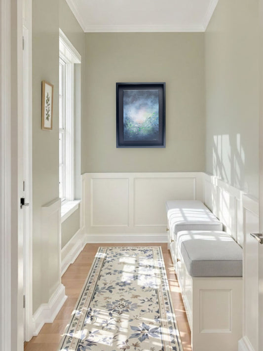 A serene, minimalist hallway with soft sage-green walls and elegant white wainscoting. On the far wall, "Mists of Truth", and abstract painting by artist SInéad Guilfoyle