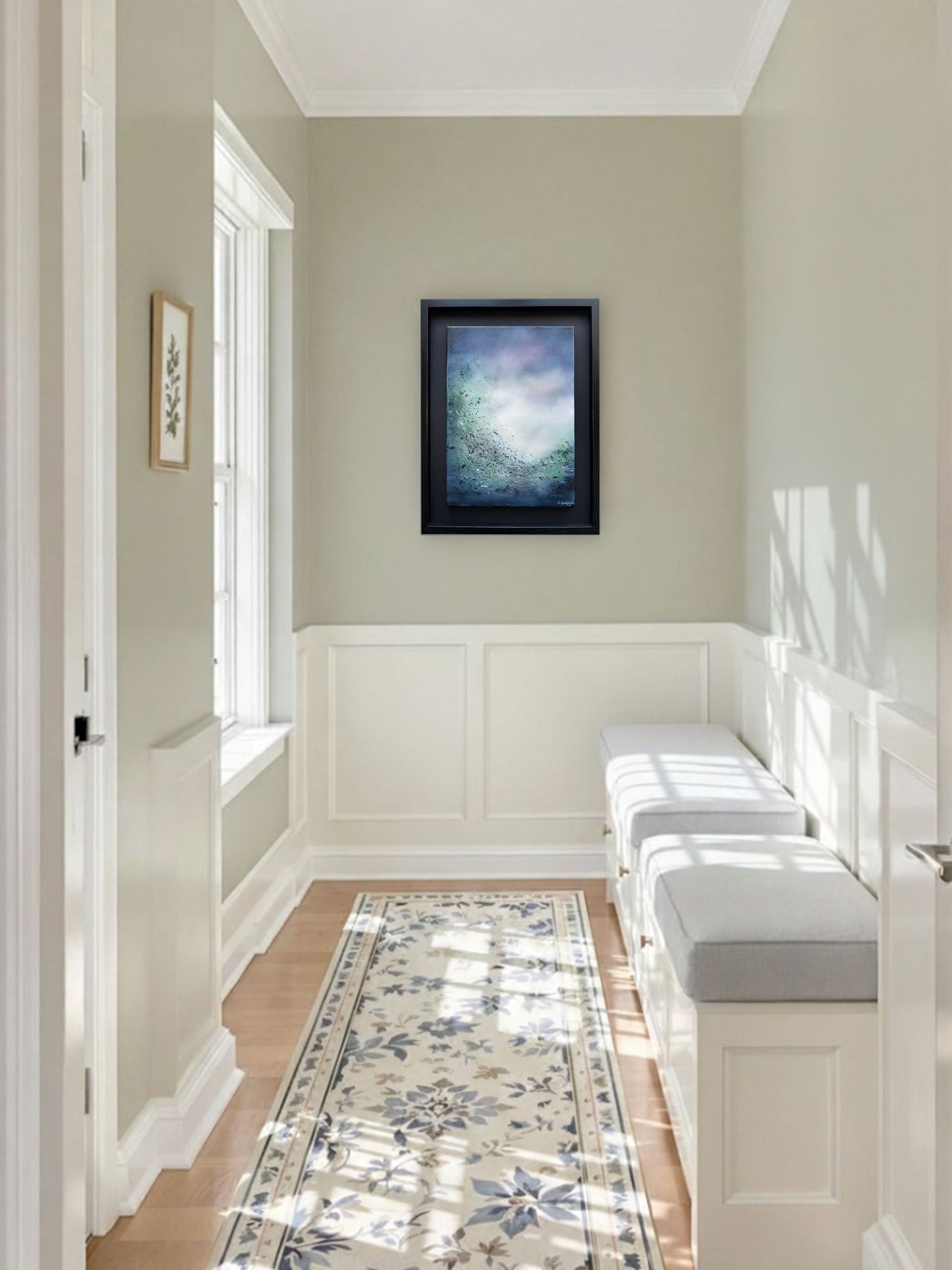 A serene, minimalist hallway with soft sage-green walls and elegant white wainscoting. On the far wall, "The Veiled Glow", and abstract painting by artist SInéad Guilfoyle