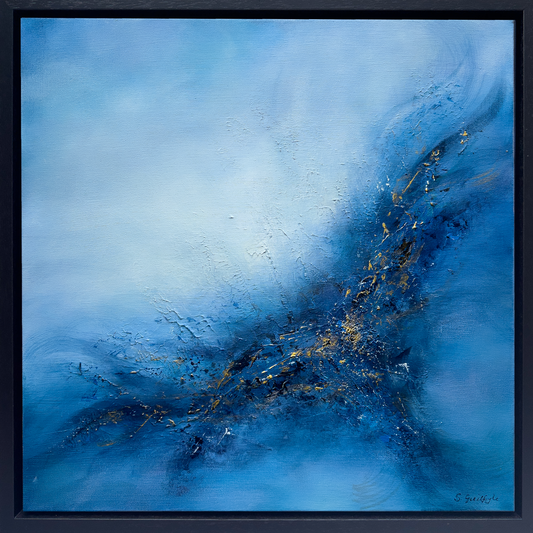 Square original abstract painting titled 'Set Free' by Sinead Guilfoyle. The artwork features a vibrant exploration of blue tones, from deep navy to ethereal sky blue, with a textured, energetic central explosion of dark indigo and shimmering gold leaf accents. The composition suggests movement and transcendence, housed in a minimalist black float frame.